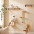 Three cats on a cat tree with shelves and a scratching post against a beige wall.